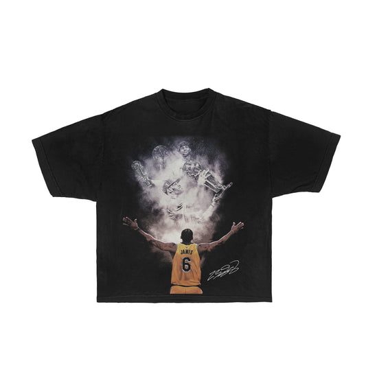 Image description: A graphic tee featuring LeBron James in action, with a bold design declaring him the GOAT (Greatest of All Time). This comfortable and stylish LeBron James graphic tee is a tribute to the basketball legend and a must-have for fans who want to showcase their admiration for his greatness.