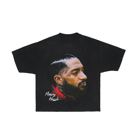 A Nipsey Hussle Graphic Tee featuring a relaxed fit, crafted from 100% ring-spun cotton. The shirt is garment-dyed for a lived-in feel and minimal shrinkage. The design includes a classic width, rib collar and shoulder-to-shoulder twill tape. A tribute to Nipsey Hussle, this Crenshaw T-Shirt is a perfect blend of style and comfort.